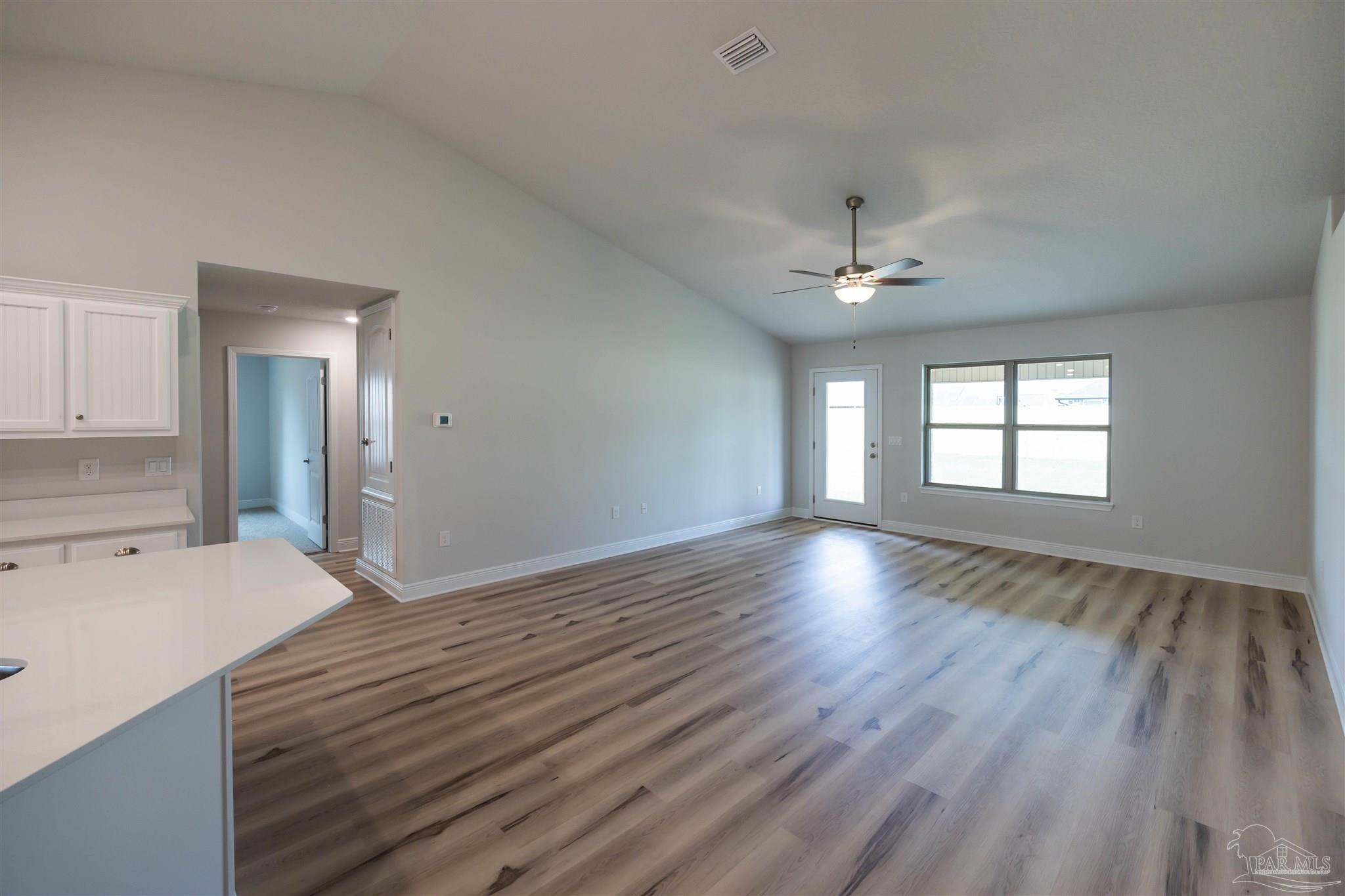 6288 Pineapple Drive Milton, FL 32570 - Photo 20 of 32 a view of a room with a ceiling fan hardwood floor and a ceiling fan
