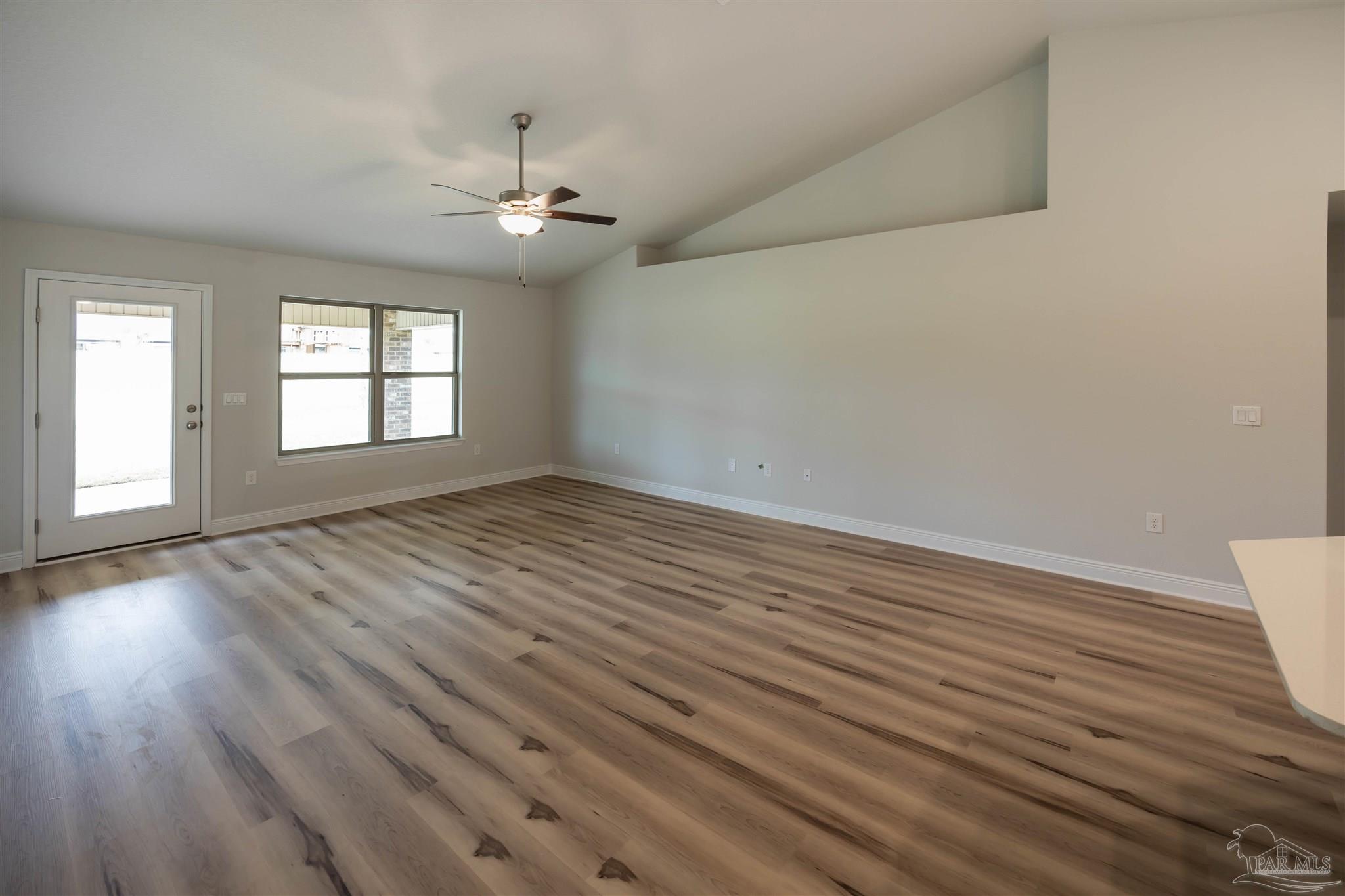 6288 Pineapple Drive Milton, FL 32570 - Photo 21 of 32 an empty room with wooden floor and windows