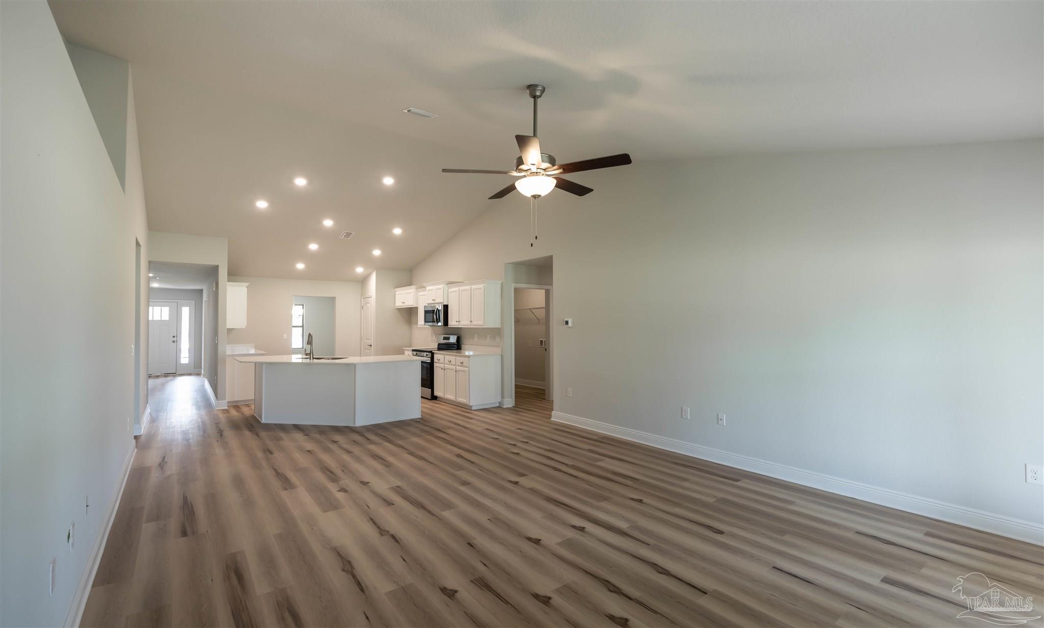 6288 Pineapple Drive Milton, FL 32570 - Photo 23 of 32 a view of a kitchen with a sink and dishwasher a refrigerator with wooden floor