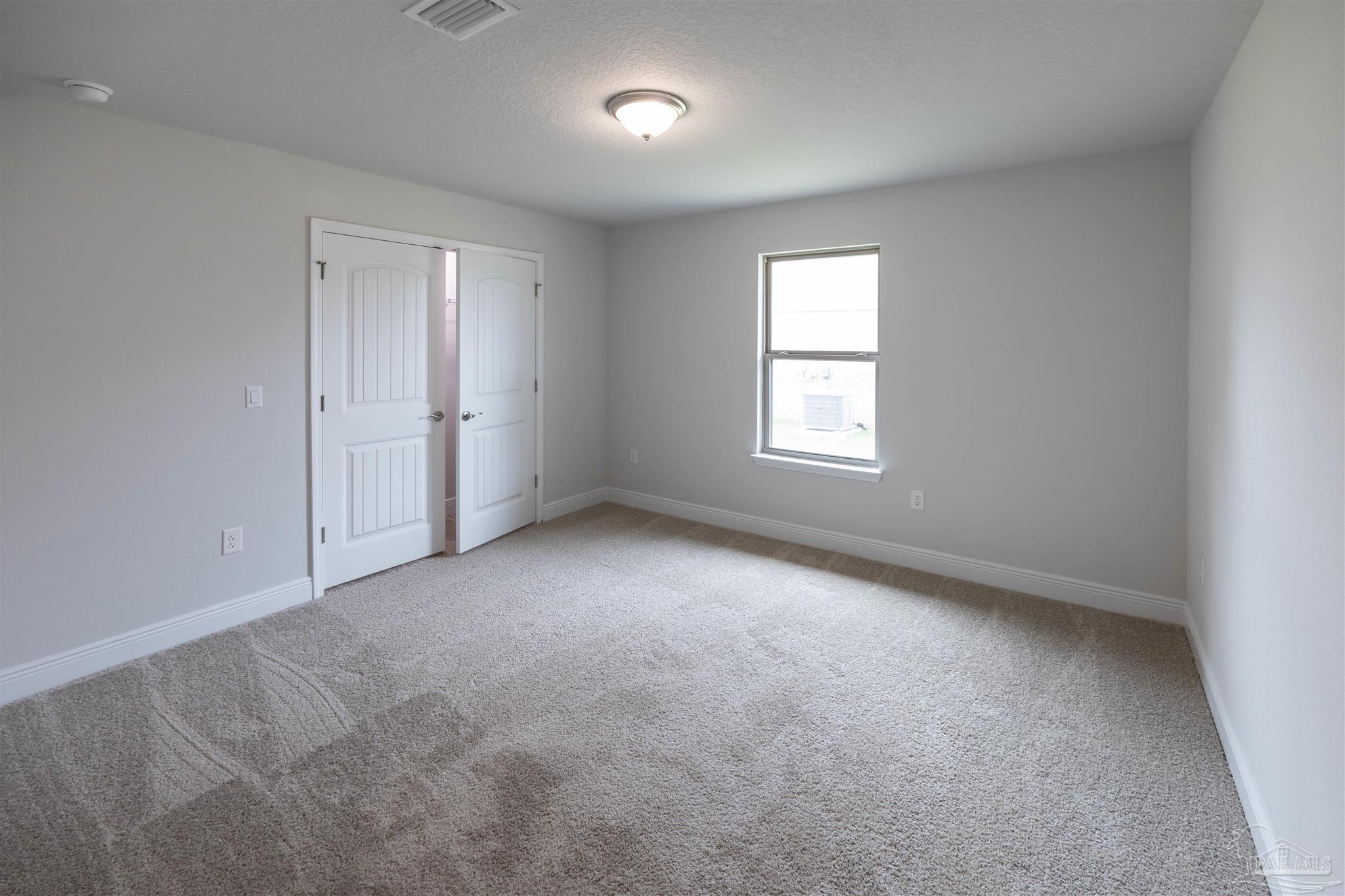 6288 Pineapple Drive Milton, FL 32570 - Photo 25 of 32 an empty room with windows and closet