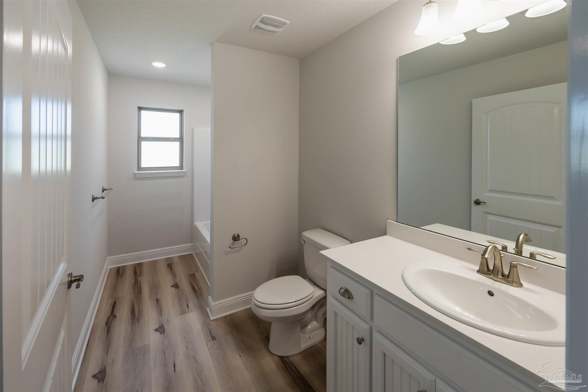 6288 Pineapple Drive Milton, FL 32570 - Photo 26 of 32 a bathroom with a sink a toilet a shower and a mirror