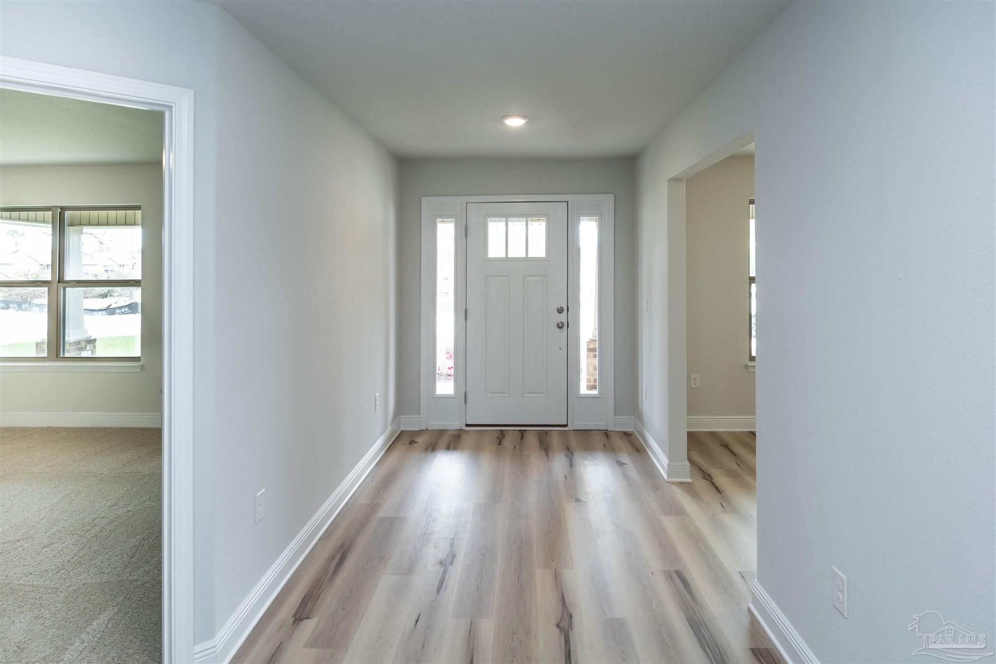6288 Pineapple Drive Milton, FL 32570 - Photo 4 of 32 a view of a room with wooden floor and window