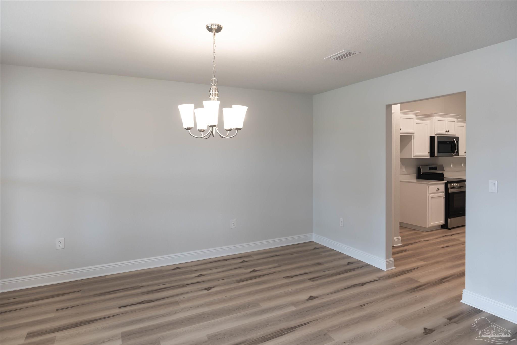 6288 Pineapple Drive Milton, FL 32570 - Photo 6 of 32 a view of a kitchen with wooden floor and a kitchen