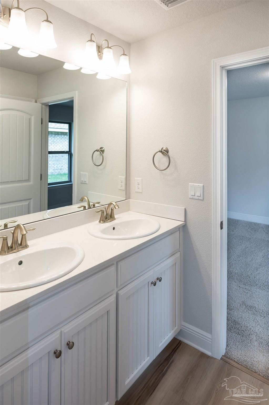 6288 Pineapple Drive Milton, FL 32570 - Photo 10 of 32 a bathroom with a double vanity sink mirror and double