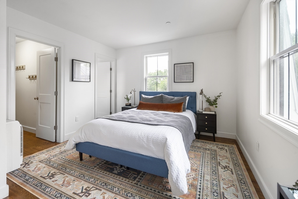 9 Cedar Street, Unit 1 Boston, MA 02119 - Photo 11 of 29 a bedroom with a large bed and a window