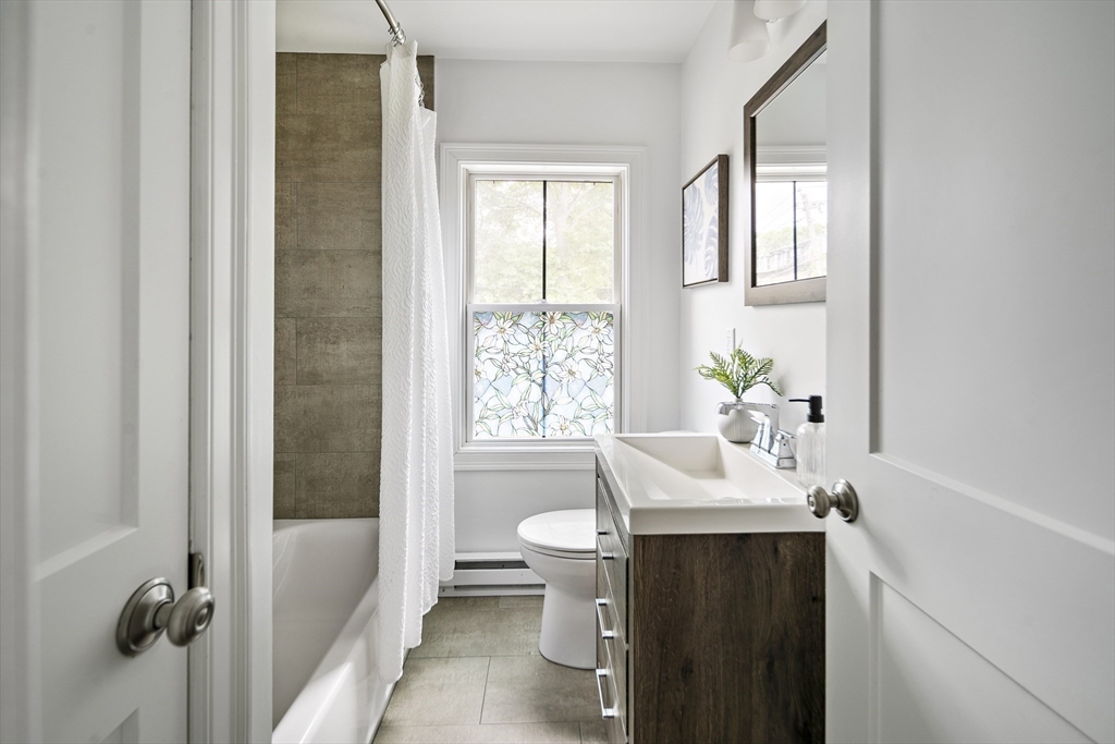 9 Cedar Street, Unit 1 Boston, MA 02119 - Photo 20 of 29 a bathroom with a sink toilet and shower