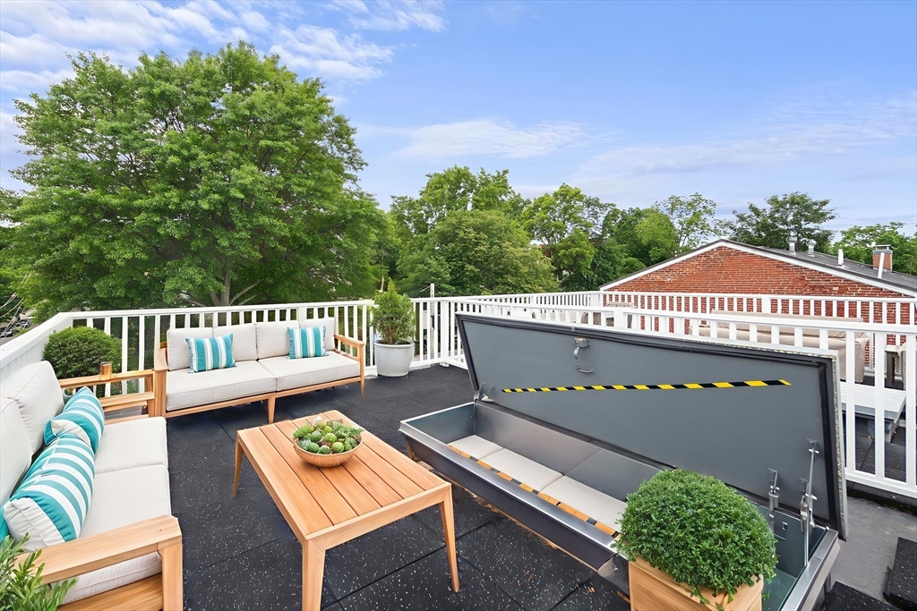 9 Cedar Street, Unit 1 Boston, MA 02119 - Photo 25 of 29 a view of a patio with couches table and chairs and potted plants