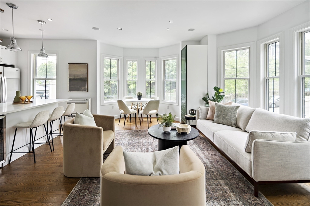 9 Cedar Street, Unit 1 Boston, MA 02119 - Photo 6 of 29 a living room with furniture and large windows