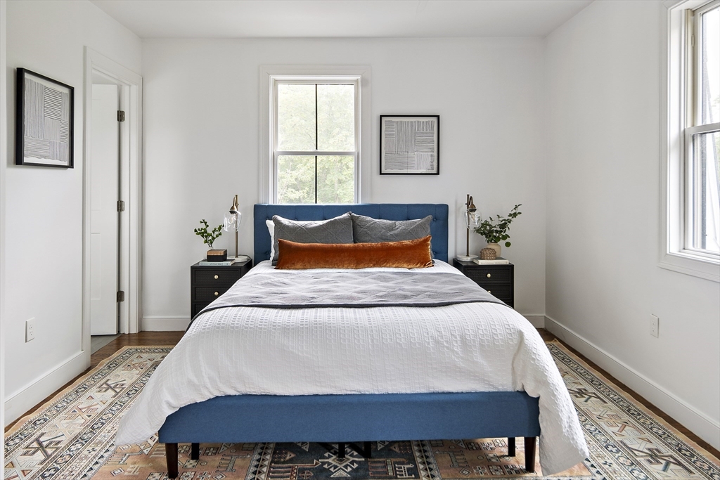 9 Cedar Street, Unit 1 Boston, MA 02119 - Photo 10 of 29 a bedroom with a bed a window and potted plant