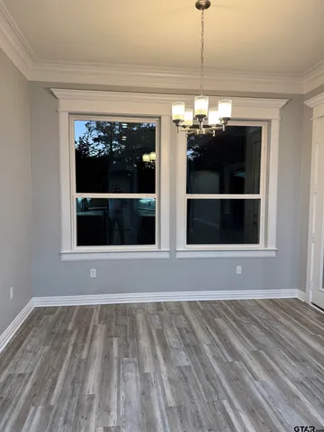 a view of room with window and chandelier
