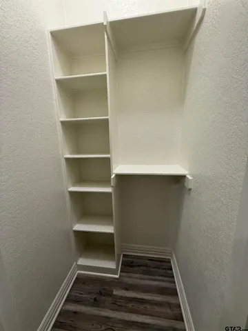 a view of a hallway with wooden floor and entryway