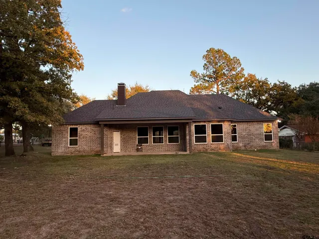 a white house that has a tree in front of it