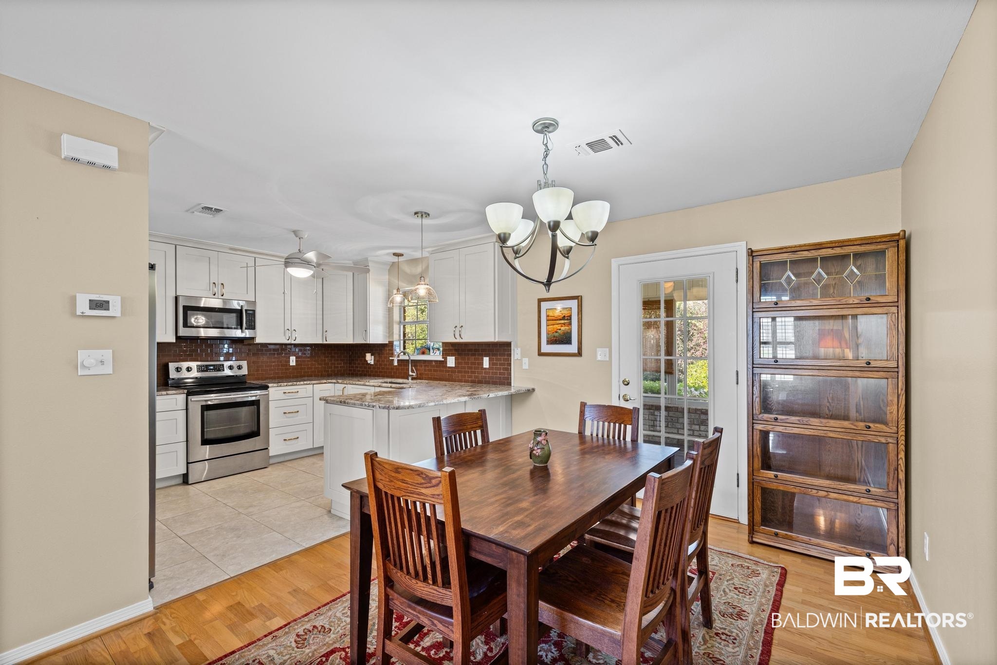 2881 Eslava Circle Lillian, AL 36549 - Photo 8 of 58 Dining room with light wood-type flooring and hanging lights