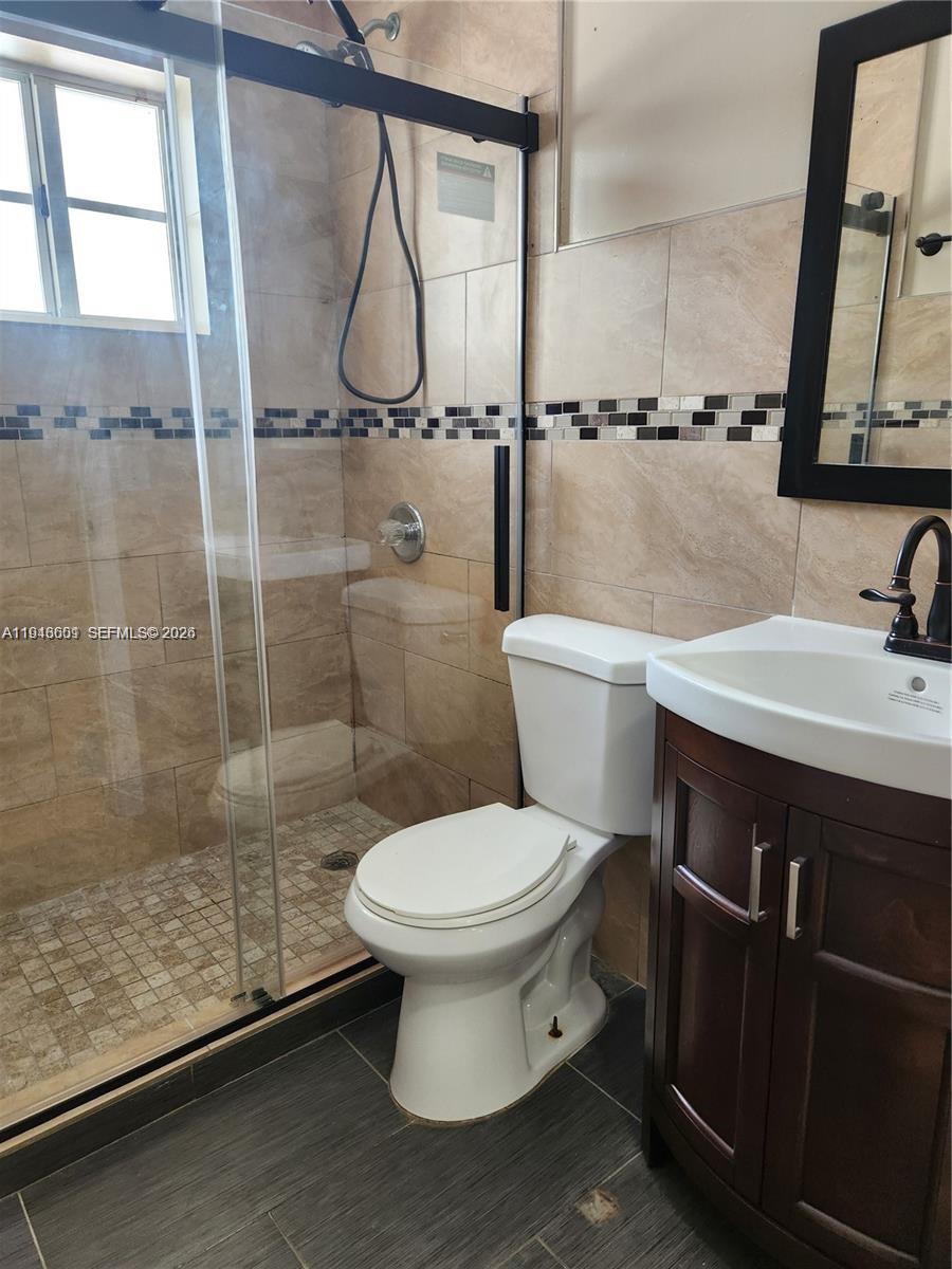 18303 Southwest 139th Place Miami, FL 33177 - Photo 16 of 19 a bathroom with a sink toilet and shower