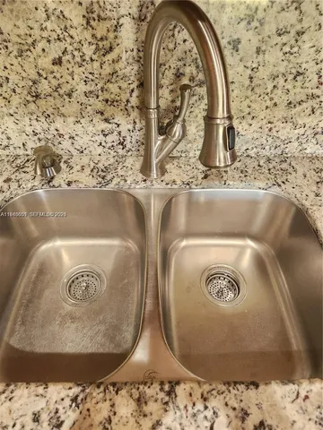 a view of a refrigerator in kitchen and an empty room