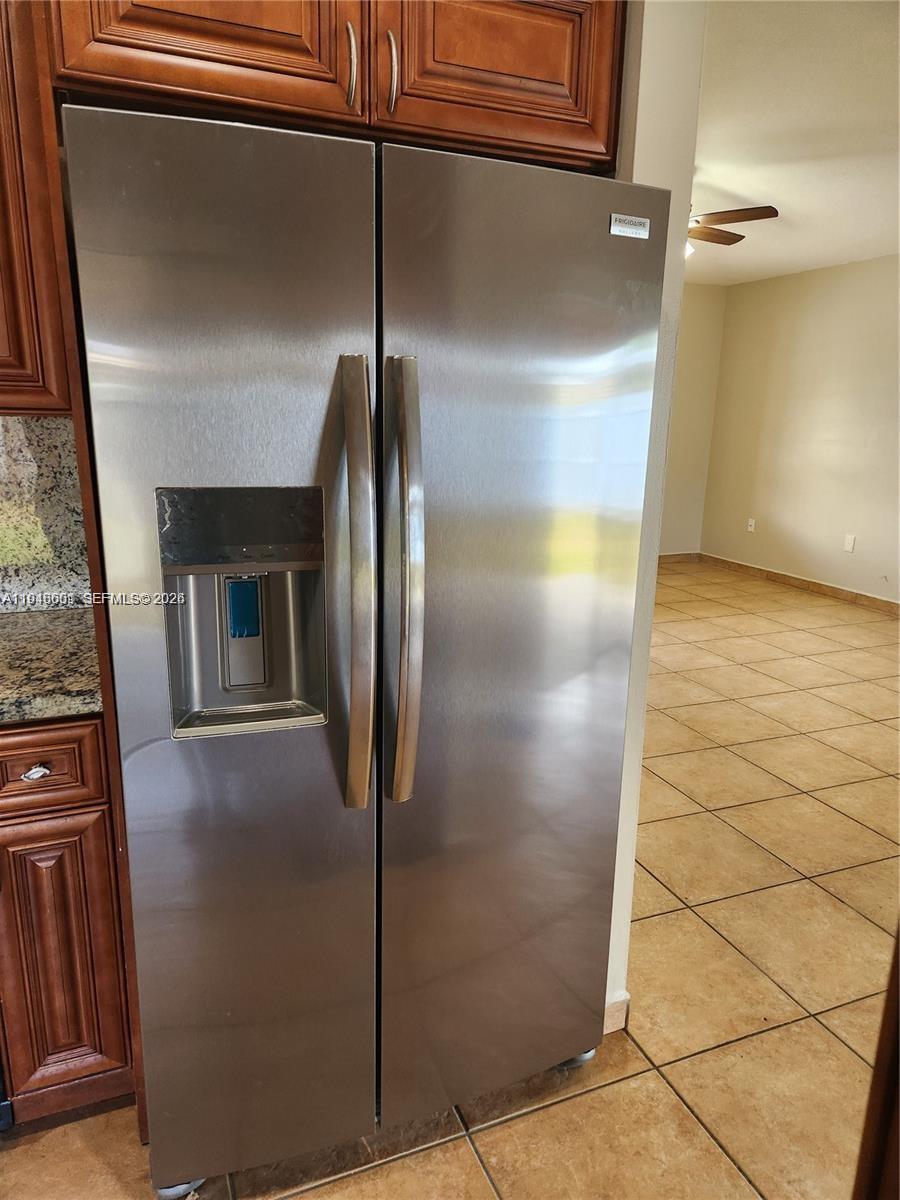 18303 Southwest 139th Place Miami, FL 33177 - Photo 8 of 19 a view of a refrigerator in kitchen and an empty room