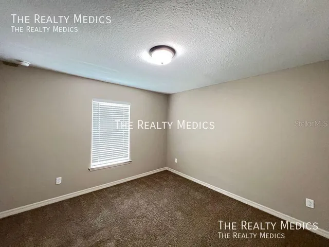 an empty room with a empty space and windows