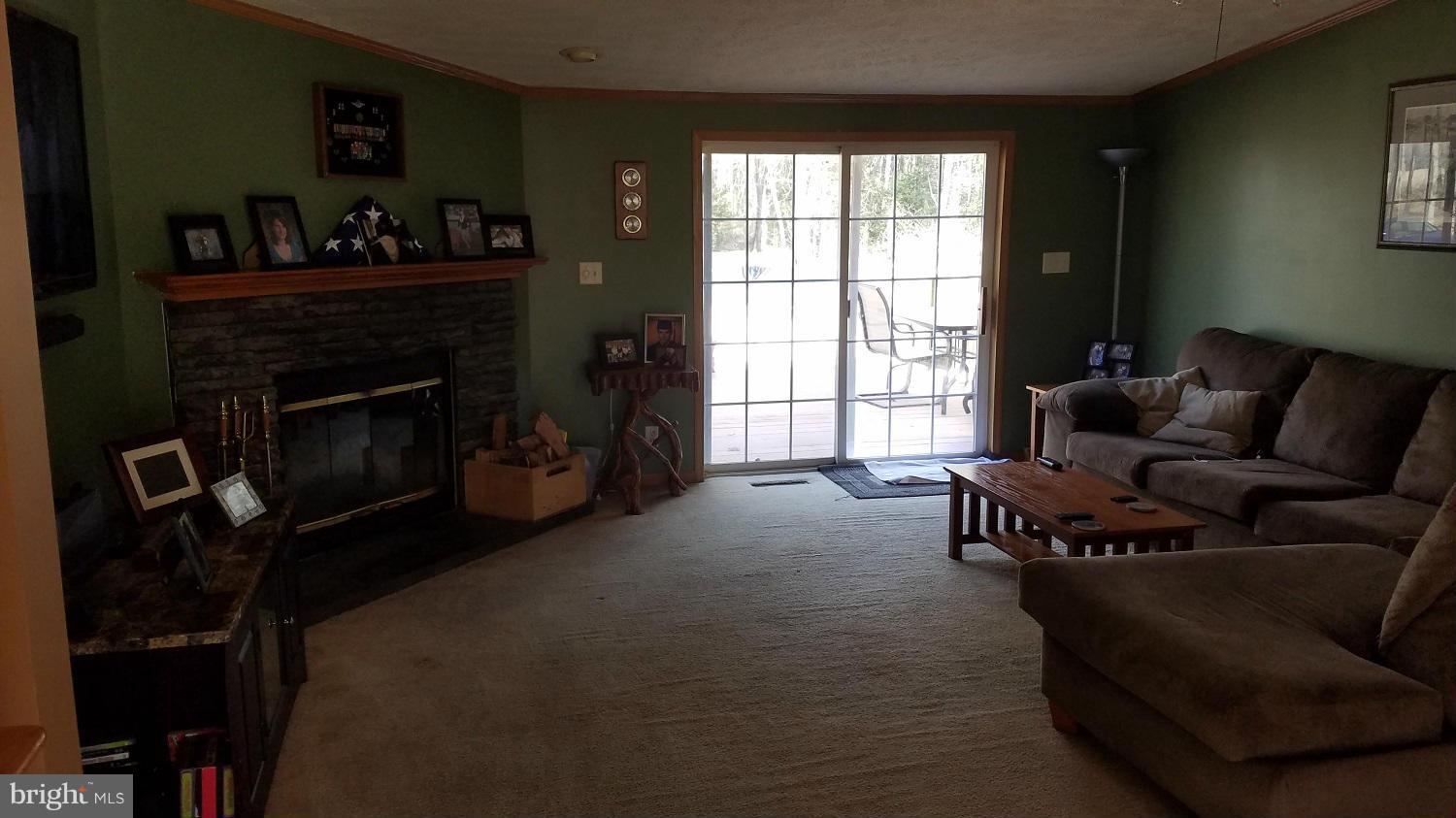 5712 Church Home Road Rhodesdale, MD 21659 - Photo 2 of 15 a living room with furniture and a fireplace