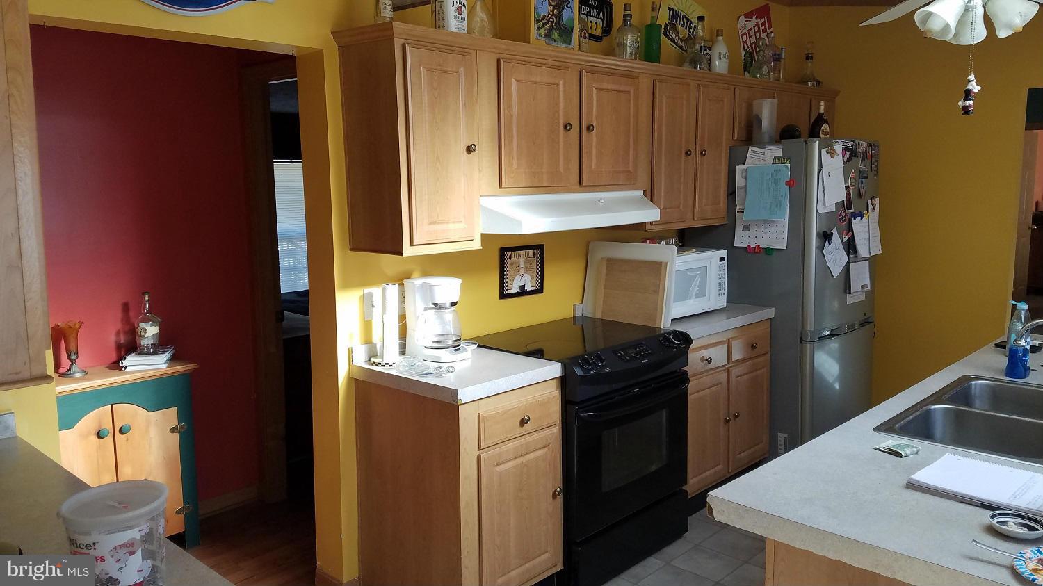 5712 Church Home Road Rhodesdale, MD 21659 - Photo 5 of 15 a kitchen with a refrigerator and a stove