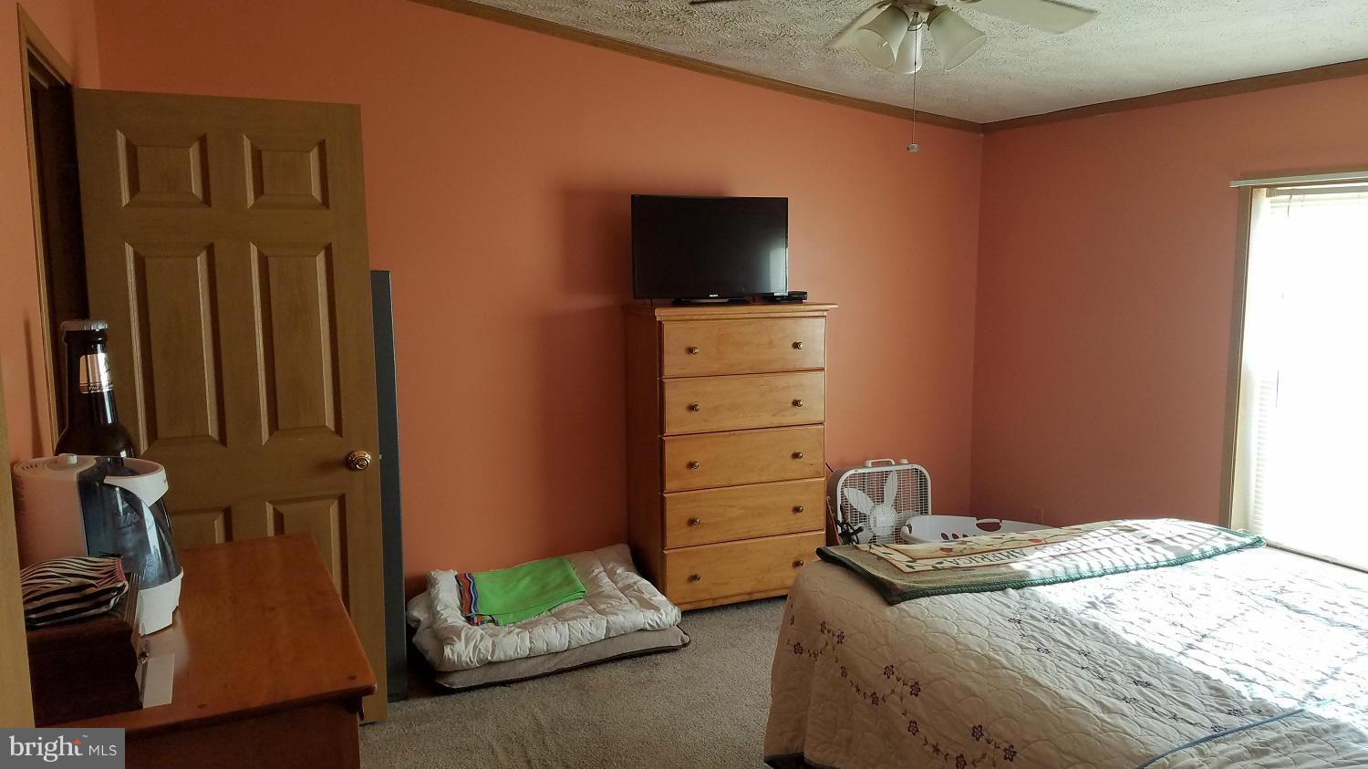 5712 Church Home Road Rhodesdale, MD 21659 - Photo 7 of 15 a bedroom with a bed and a flat tv screen