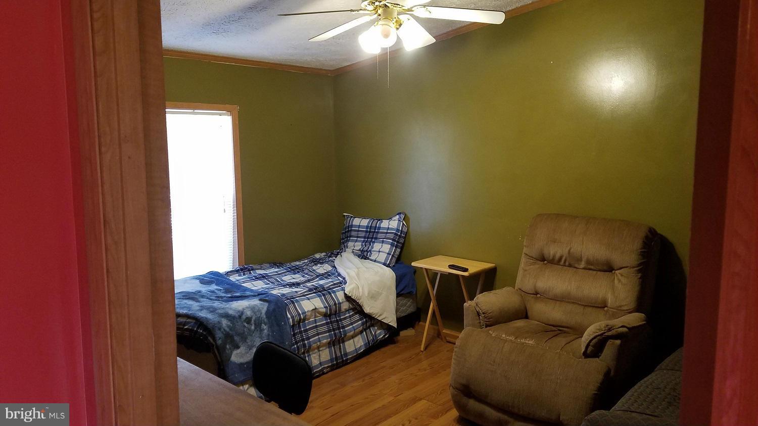 5712 Church Home Road Rhodesdale, MD 21659 - Photo 10 of 15 a bedroom with a bed and a chandelier