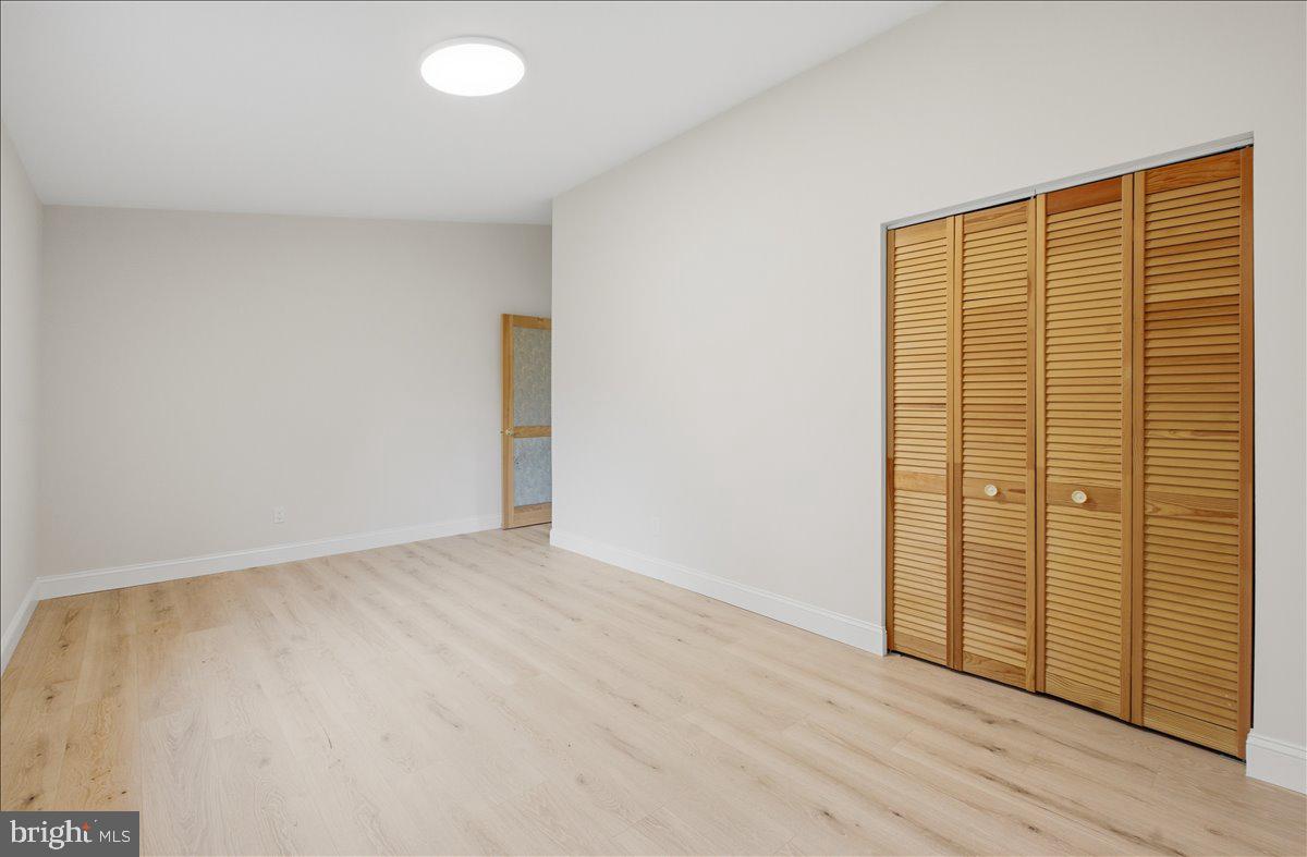 822 Walker Road Great Falls, VA 22066 - Photo 13 of 32 a view of an empty room with wooden floor and a window