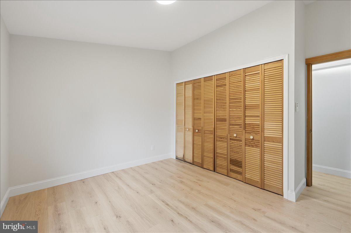 822 Walker Road Great Falls, VA 22066 - Photo 15 of 32 an empty room with wooden floor and door