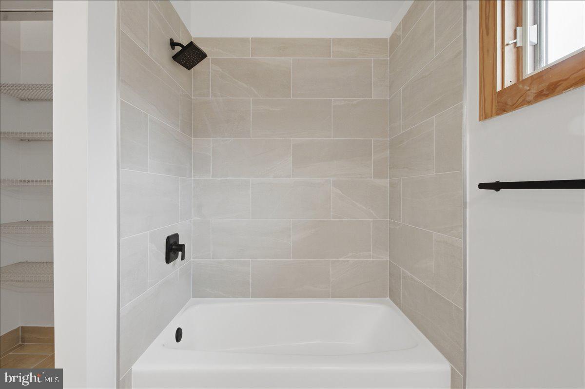 822 Walker Road Great Falls, VA 22066 - Photo 19 of 32 a bathroom with a shower and a bathtub