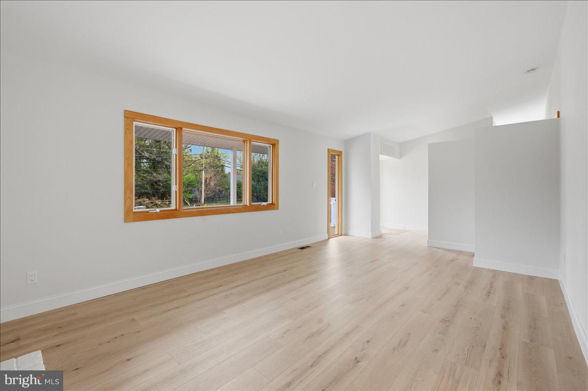 822 Walker Road Great Falls, VA 22066 - Photo 5 of 32 a view of an empty room with wooden floor and a window