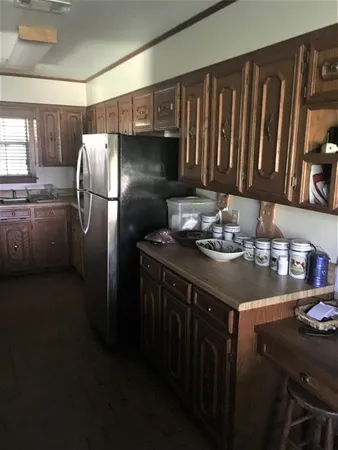 a kitchen with a sink refrigerator and microwave
