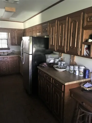 a kitchen with a sink refrigerator and microwave