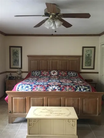 a bed sitting in a bedroom next to a lamp