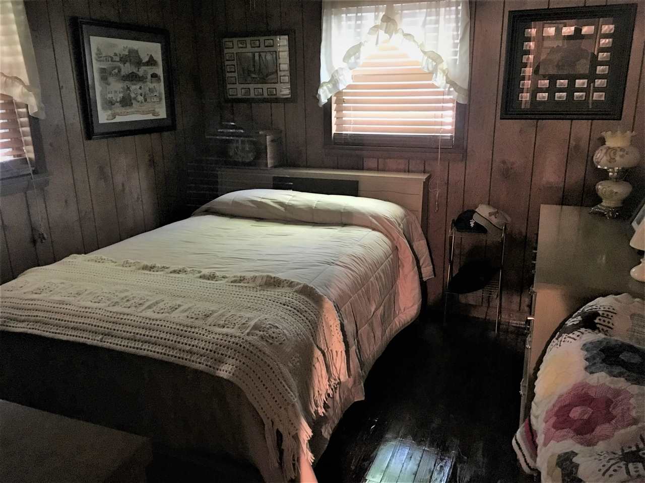 20 Butler Lane Collins, MS 39428 - Photo 8 of 24 a bedroom with a bed and a painting on the wall