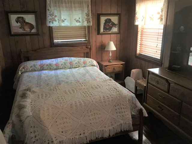 a bedroom with a bed and window