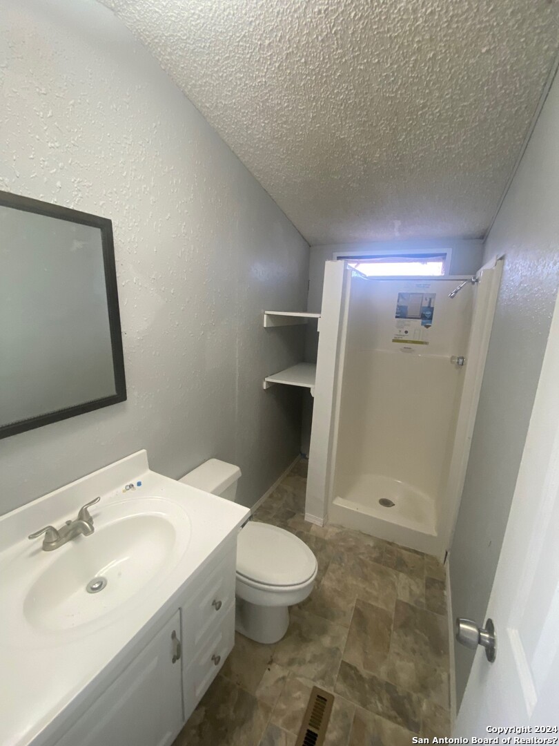 1311 Hein Road West, Unit 19 San Antonio, TX 78220 - Photo 2 of 8 a bathroom with a sink toilet and shower