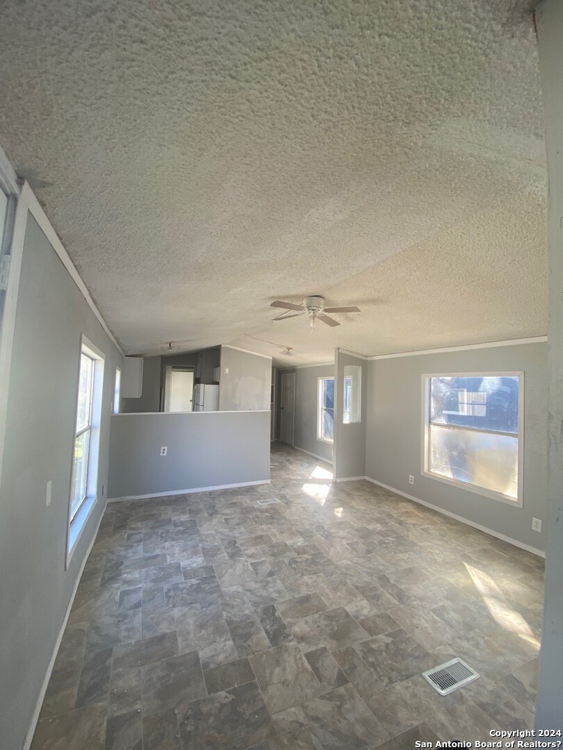 1311 Hein Road West, Unit 19 San Antonio, TX 78220 - Photo 6 of 8 a view of empty room with window and fireplace