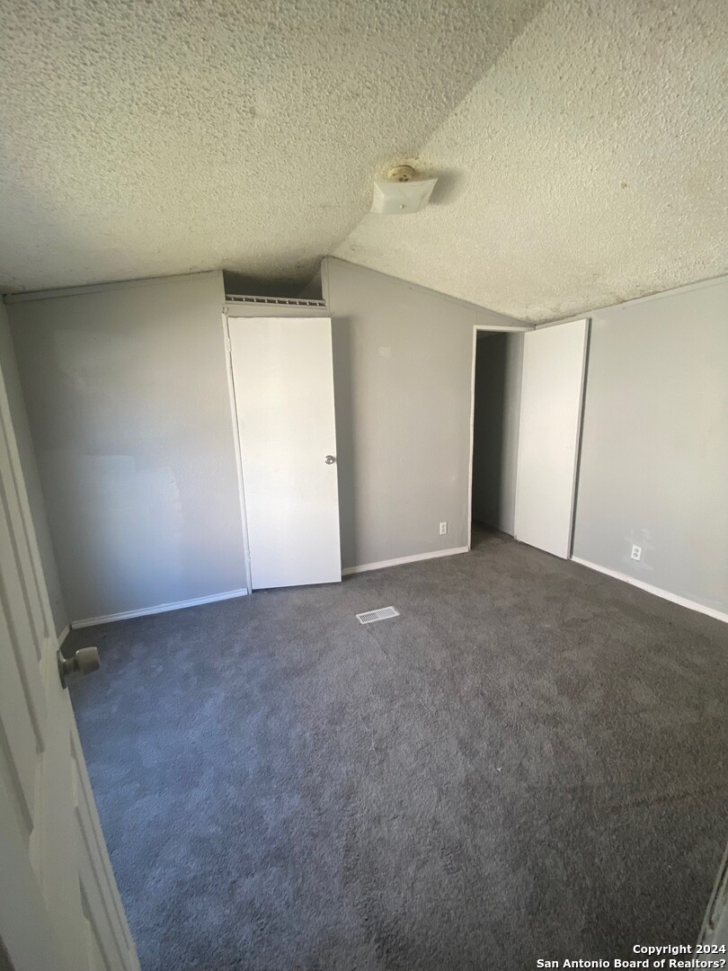 1311 Hein Road West, Unit 19 San Antonio, TX 78220 - Photo 8 of 8 an empty room with a empty space and windows