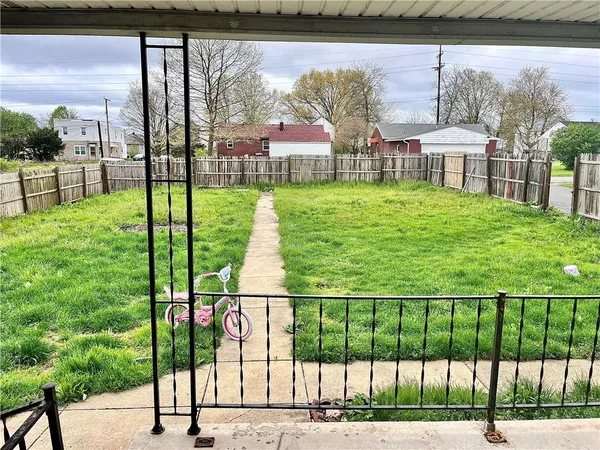 a view of a house with a yard table and chairs