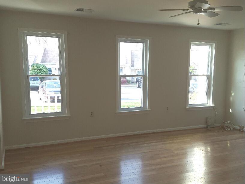 Sunny large living room, ceiling fan
