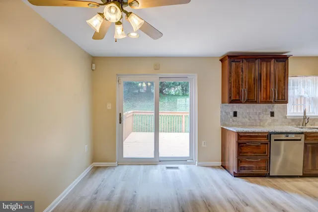 a view of room with wooden floor and fan
