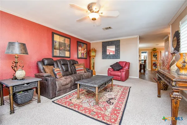 a living room with furniture a rug and a wall painting