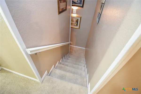 a bedroom with a bed and a lamp
