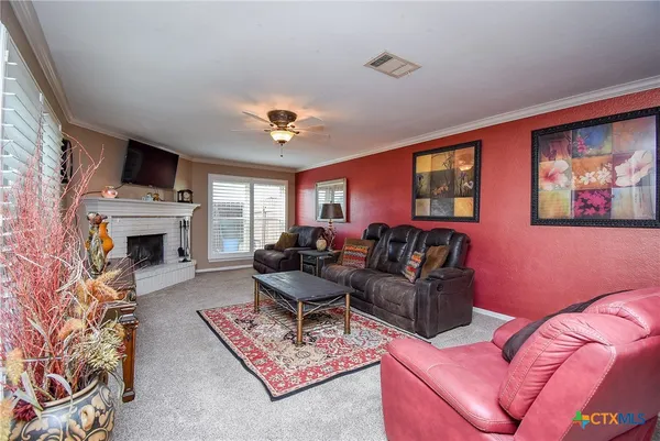 a living room with furniture a fireplace and a flat screen tv