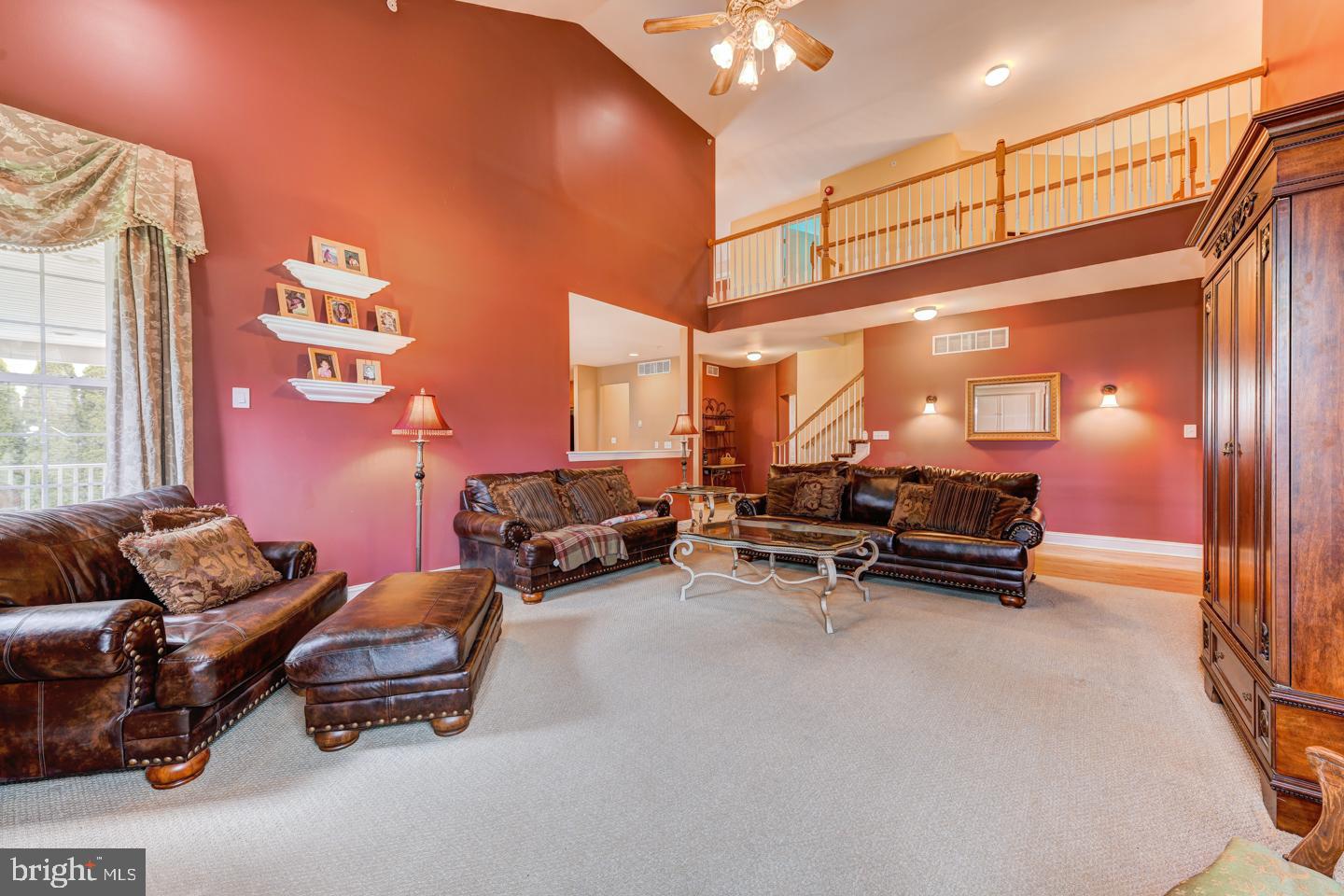 2147 Brookshire Road Furlong, PA 18925 - Photo 14 of 39 a living room with furniture a rug and a chandelier