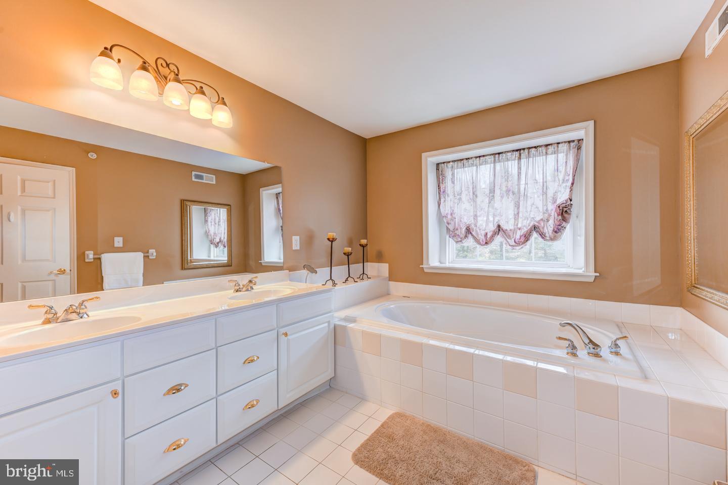 2147 Brookshire Road Furlong, PA 18925 - Photo 25 of 39 a spacious bathroom with double vanity sinks a large mirror and a bathtub