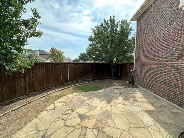 a view of small yard with wooden fence