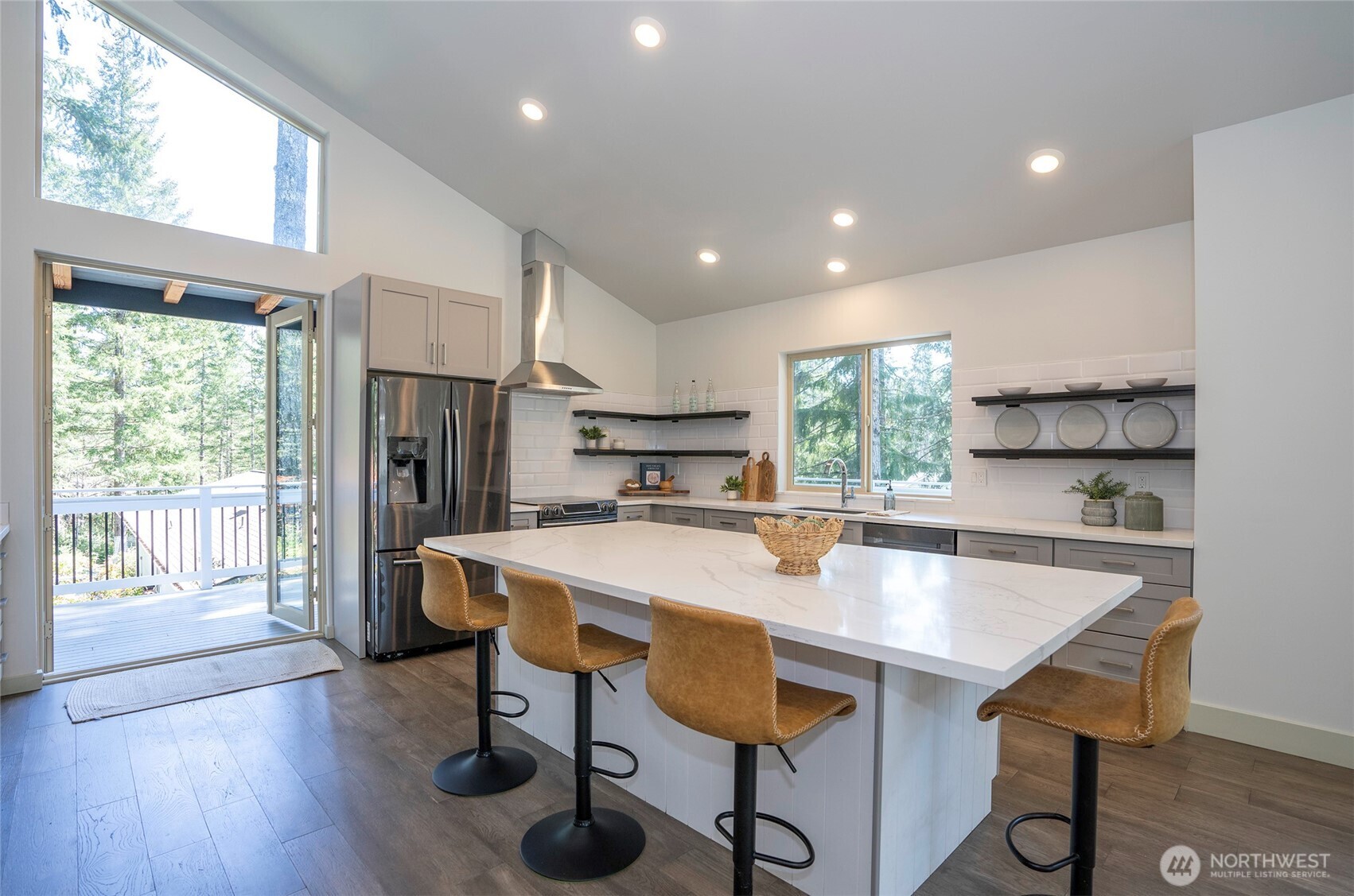240 East Susan Lane Union, WA 98592 - Photo 11 of 40 a large kitchen with kitchen island a table and chairs in it