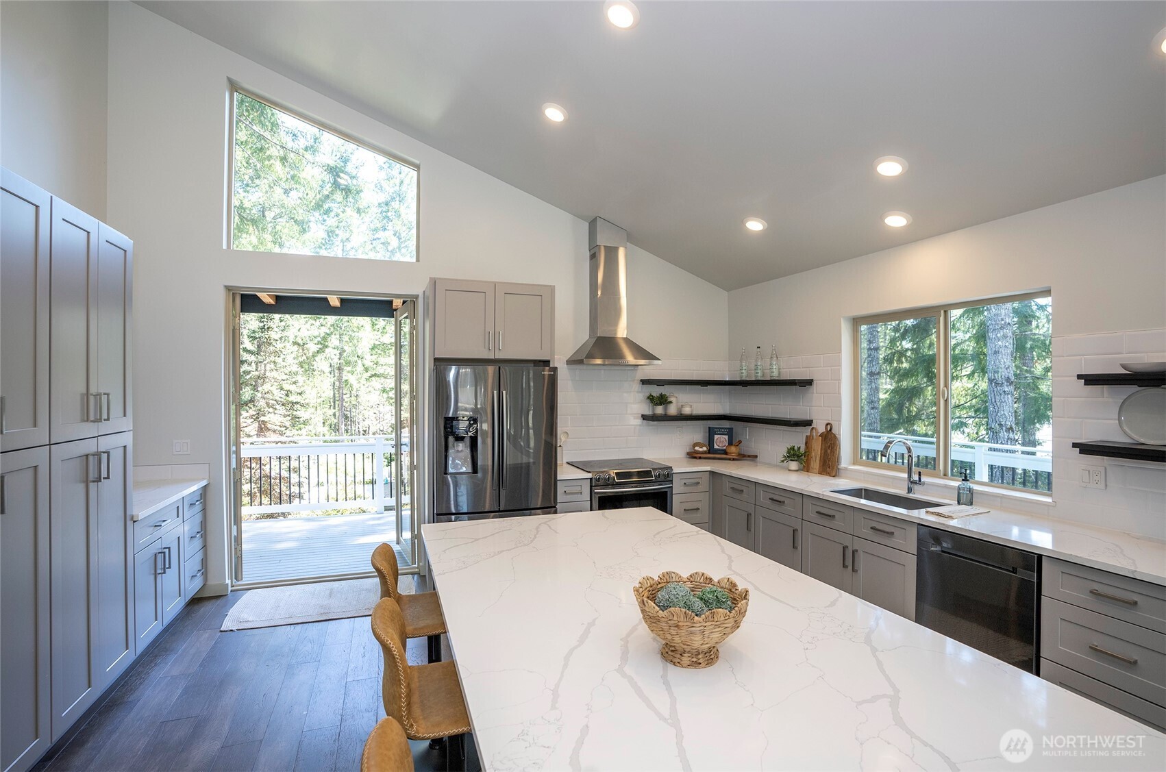 240 East Susan Lane Union, WA 98592 - Photo 15 of 40 a kitchen with stainless steel appliances granite countertop a refrigerator a sink dishwasher a stove and white countertops with wooden floor
