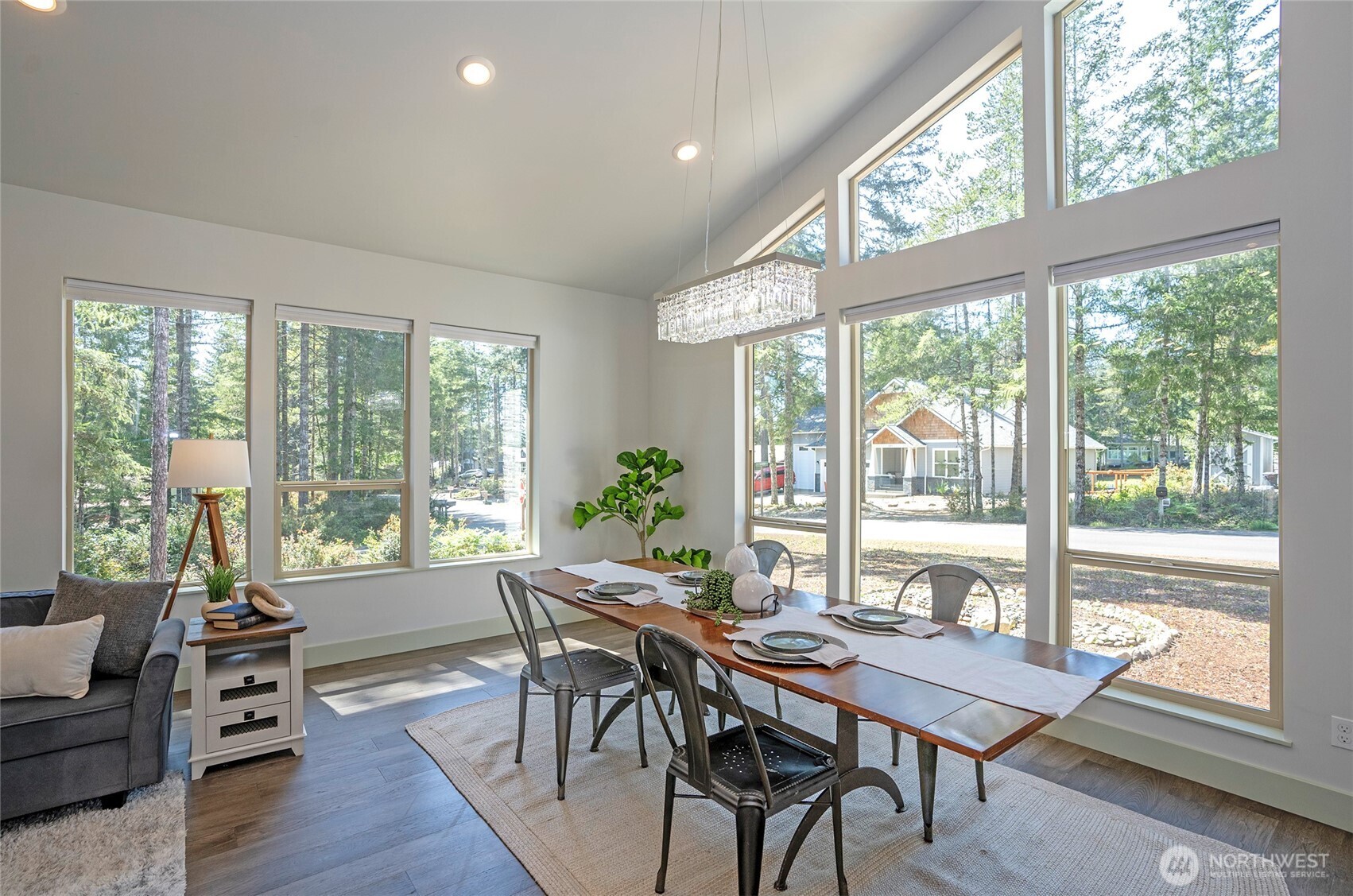240 East Susan Lane Union, WA 98592 - Photo 10 of 40 a view of a dining room with furniture large windows and wooden floor
