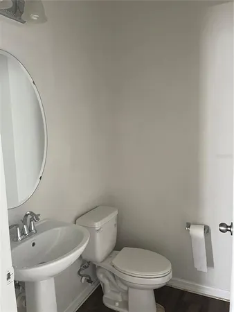 a white toilet sitting next to a bathroom sink